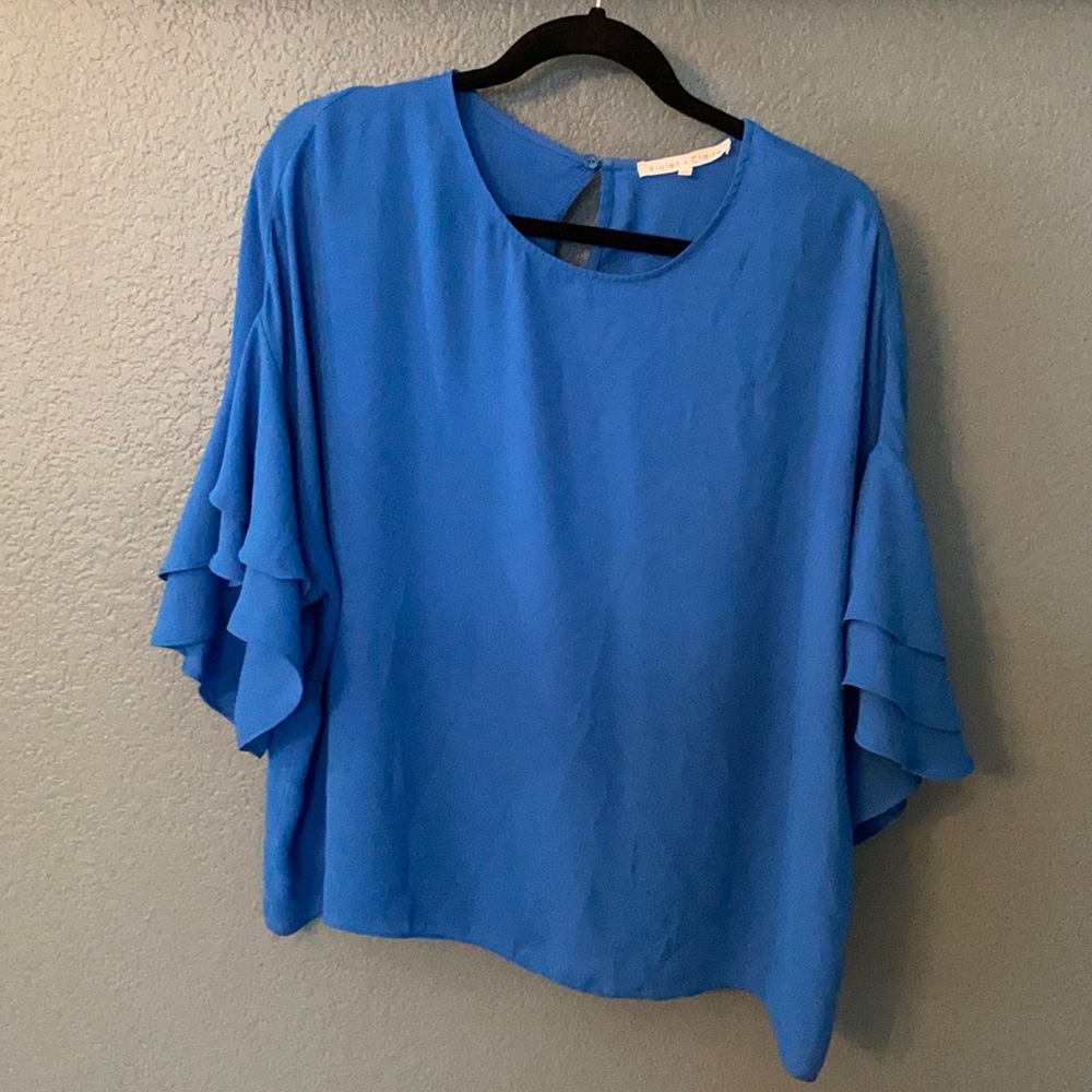 Roy’s blue polyester blouse.